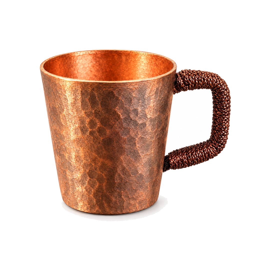 Woven handle copper espresso cup on a white background