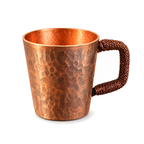 Woven handle copper espresso cup on a white background