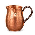 Hammered copper milk and coffee pot on a white background
