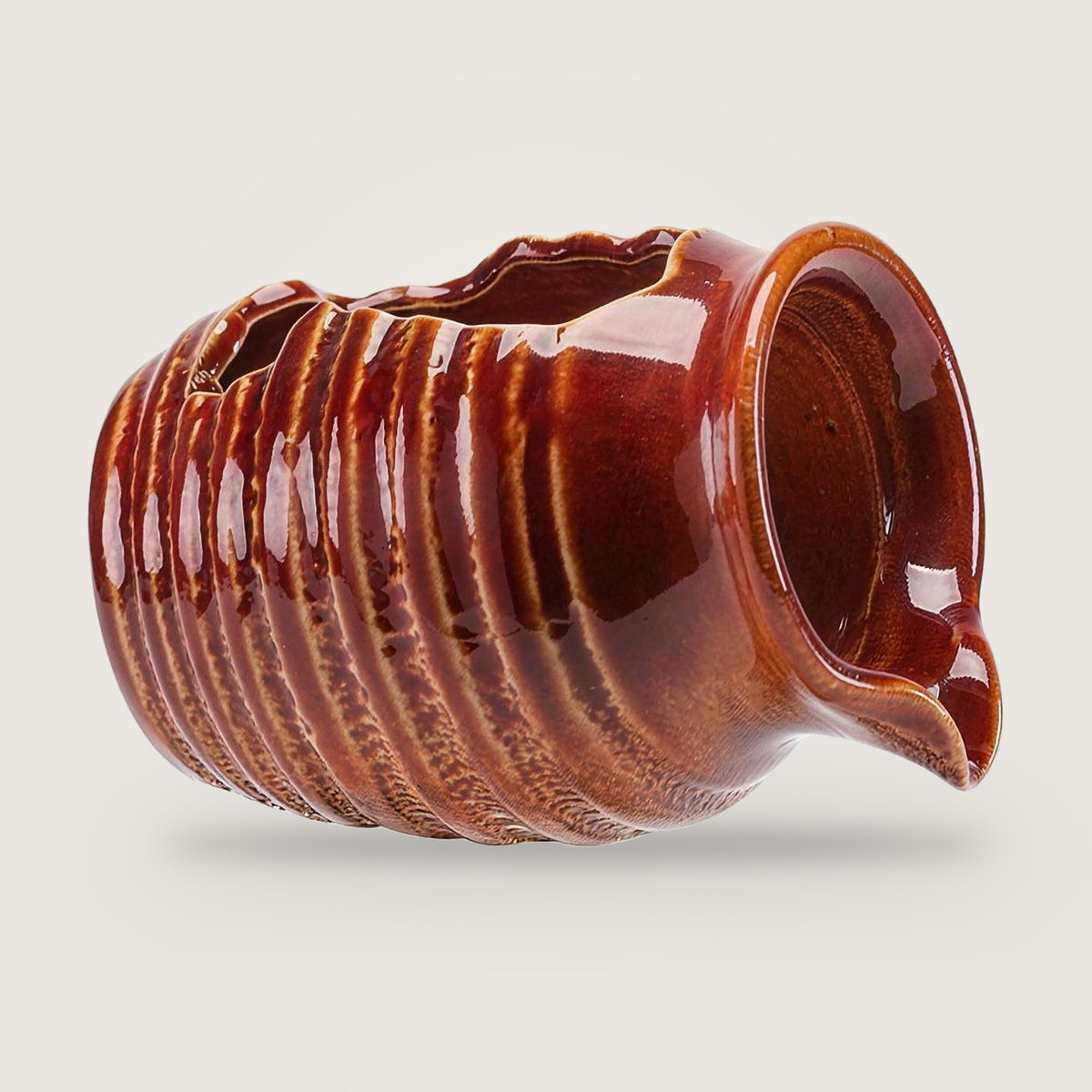 Ceramic water feature jug, Glazed Red option, on a plain light grey background