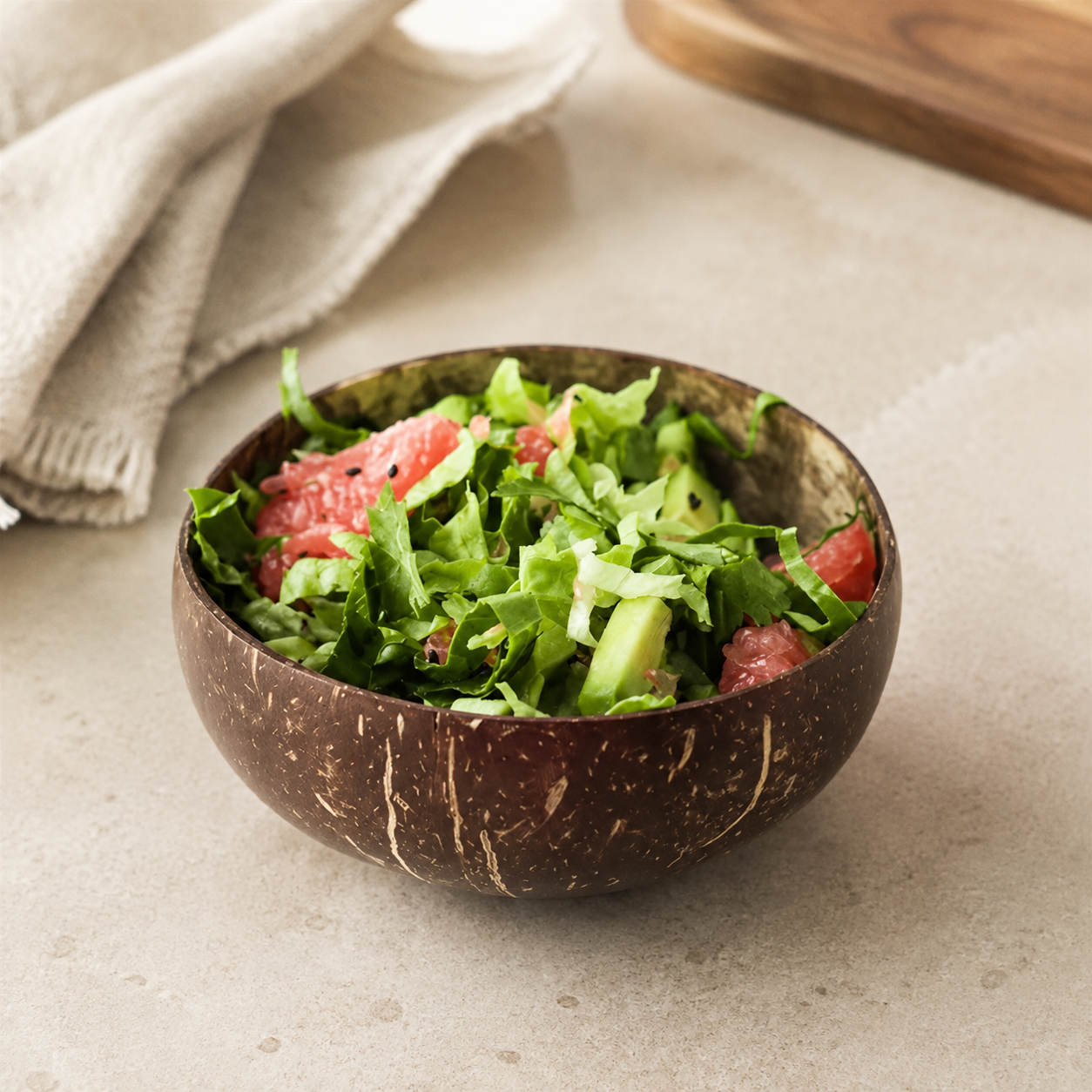 Coconut shell serving bowl on a warm cream stone surface