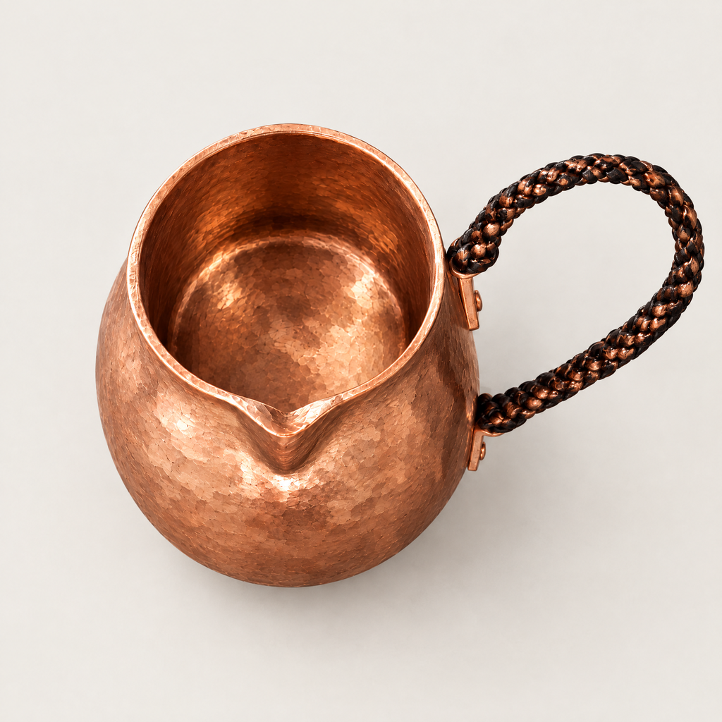 Overhead view of the copper pot showing the rim and spout