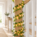 Ivy leaf fairy lights wound around a wooden bannister post
