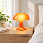 USB mushroom table lamp lit on a bedside table