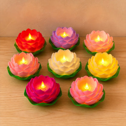 Colourful Luma LED lotus candles on a natural wood surface