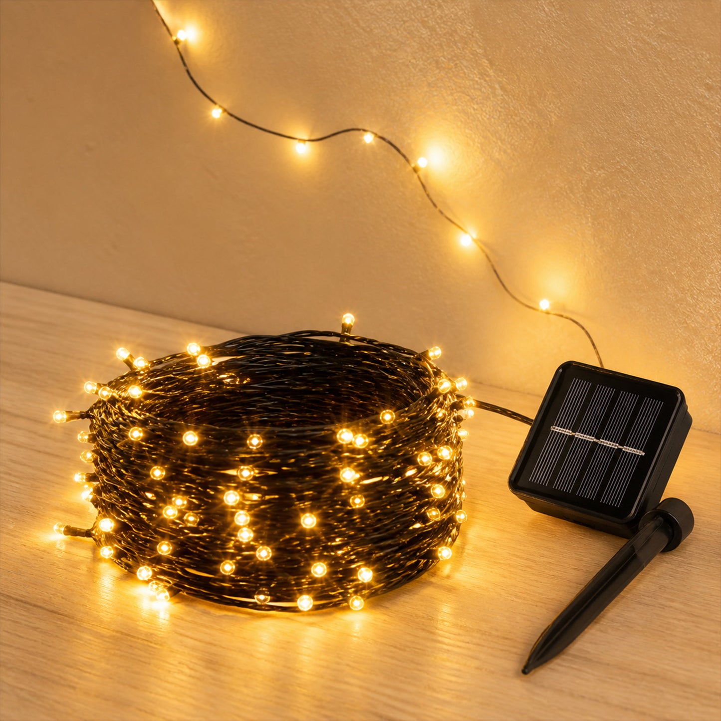 Luma solar fairy lights and solar panel on a natural wood surface