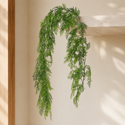 Artificial trailing foliage vine styled on a pale stone shelf